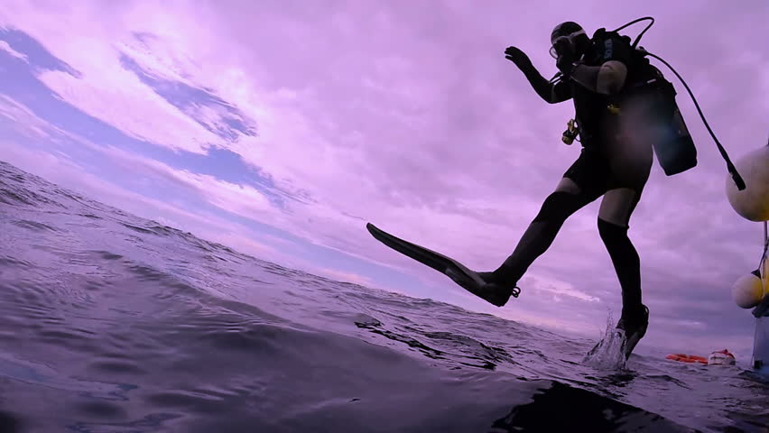 Scuba Diver Jumping Into The Ocean In Slow Motion A Scuba Diver Jumps