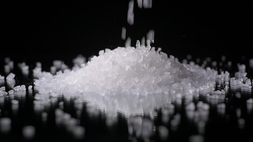 Salt Grain Crystals Falling In Slow Motion On Black Background Stock 