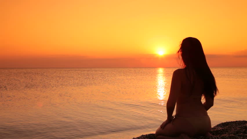 Silhouette Of A Woman Sitting On A Beach At Sunset Stock Footage Video 1338586 Shutterstock 