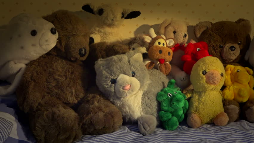 bed covered in stuffed animals