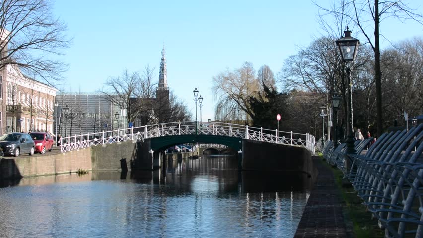 View of a small bridge in Leiden on a sunny winter day, South Holland, Netherlands - HD stock video clip