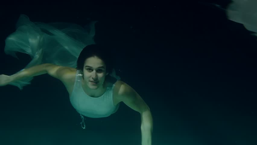 Happy Brunette Waving At Camera Underwater In Swimming