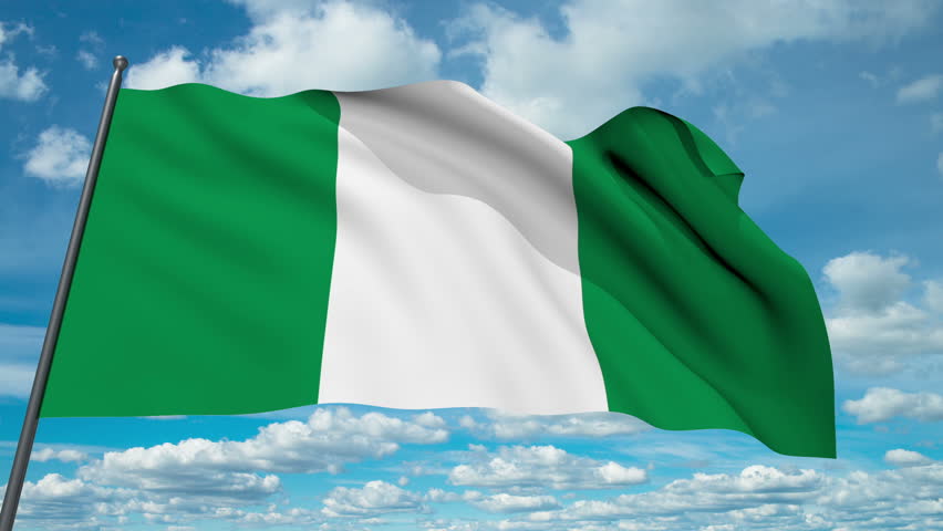 Nigeria flag waving against time-lapse clouds background - HD stock