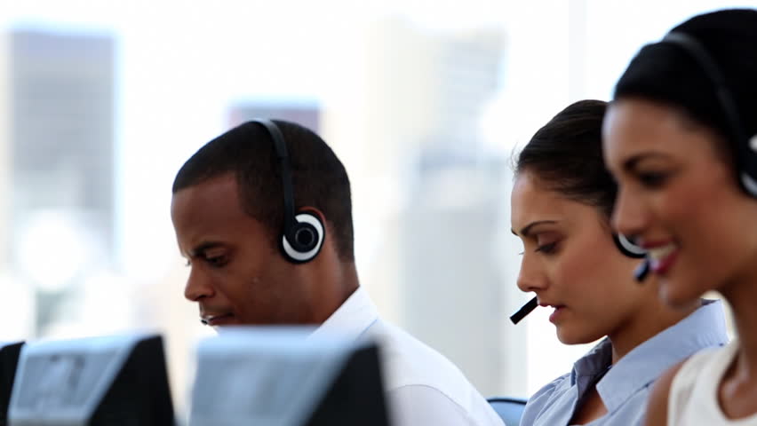 Call Centre Agents Working In Their Bright Office Stock Footage Video