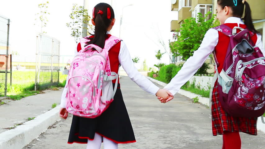 Little Student Girls With Bags Going To School In City 