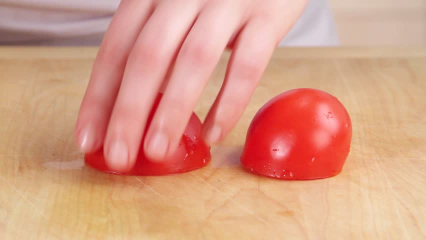 A Tomato Being Cut Into Wedges Stock Footage Video 2449175   Shutterstock