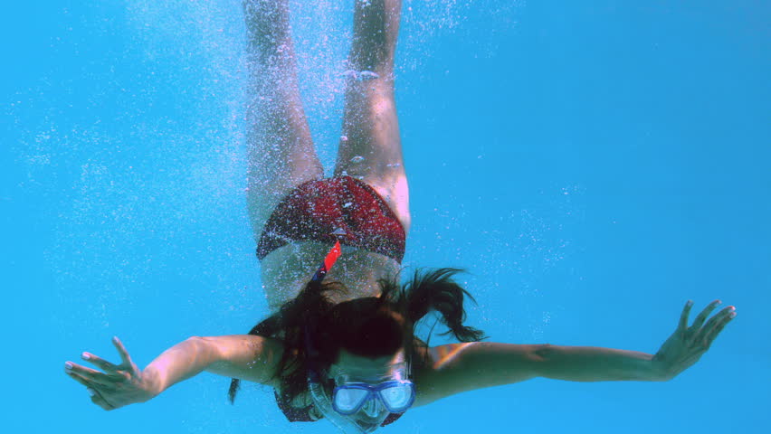 Happy Brunette Underwater In Swimming Pool Wearing Snorkel