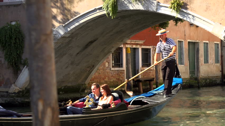  are punted along a Venice canal in a gondola - HD stock video clip