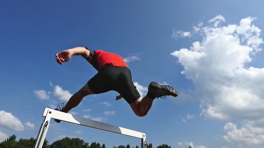 Athlete Jumping Over A Hurdle In Track And Field In Slow Motion Stock 