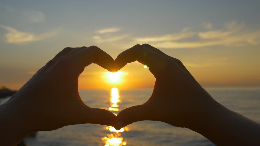 Ocean Sunset Shining Through Heart Shaped Hands Stock Footage Video 