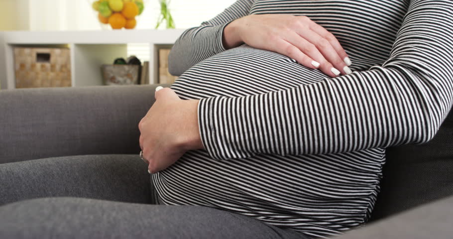 Pregnant Woman Sitting On Couch Rubbing Belly Stock Footage Video 7814374 Shutterstock 