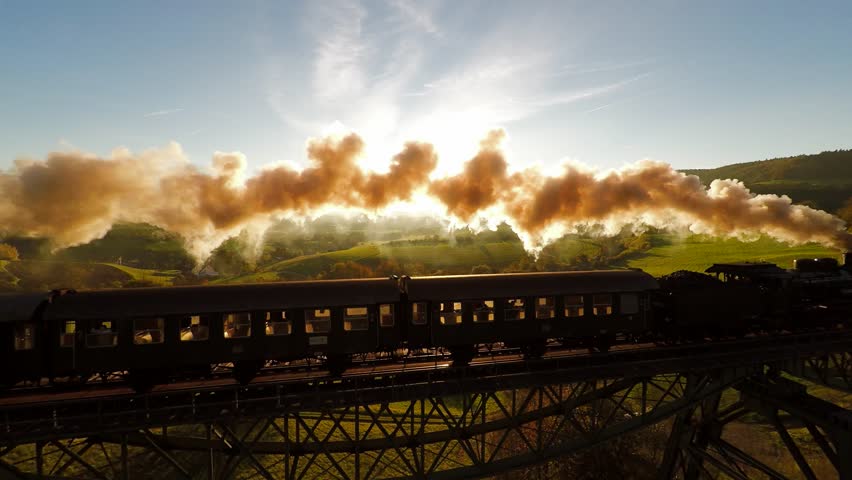 Epic Aerial View Of Steam Engine Train Crossing Bridge At Sunset Magic