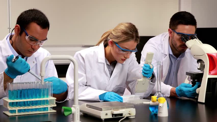 Young Scientist Looking Through Microscope In The Lab In High Quality 