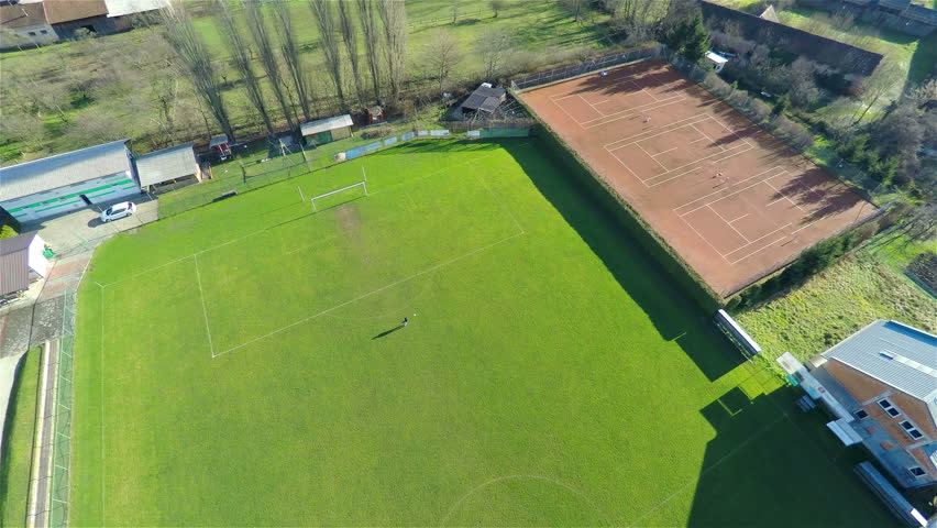 Aerial 4K Descending On Soccer Player On Empty Field. High Above The