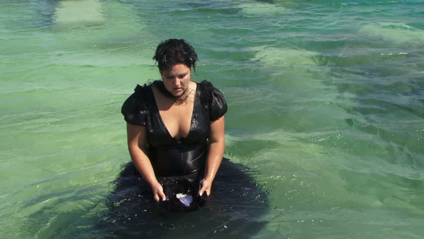 Young attractive woman in clothes swimming under water Stock video