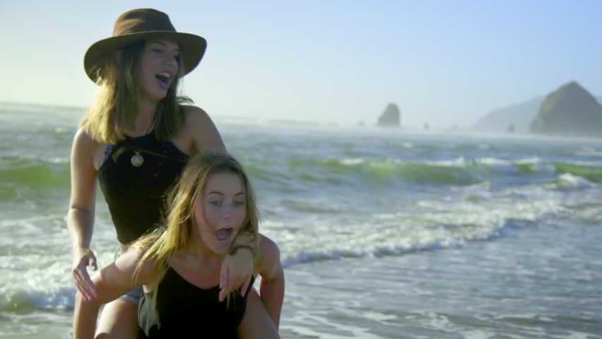 Group Of Friends Give Each Other Piggyback Rides On The Beach Stock ...