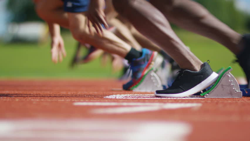 4K Group Of Athletes At Running Track, Crouch At Starting Line Before A ...