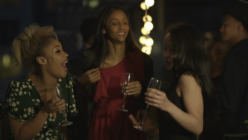 Young African American Woman Dancing Happily With Friends In A Night ...