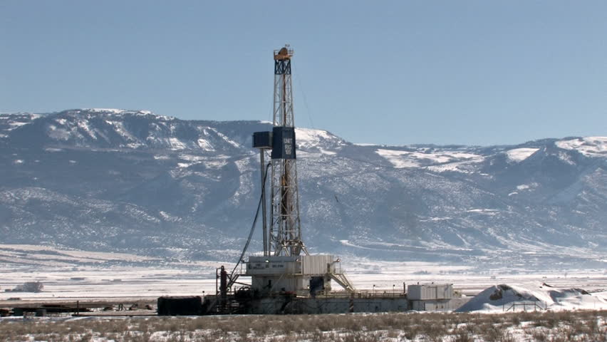 Oil Rig In A Valley Of Utah Near Mountain. Blue Sky And Snow Of Winter ...