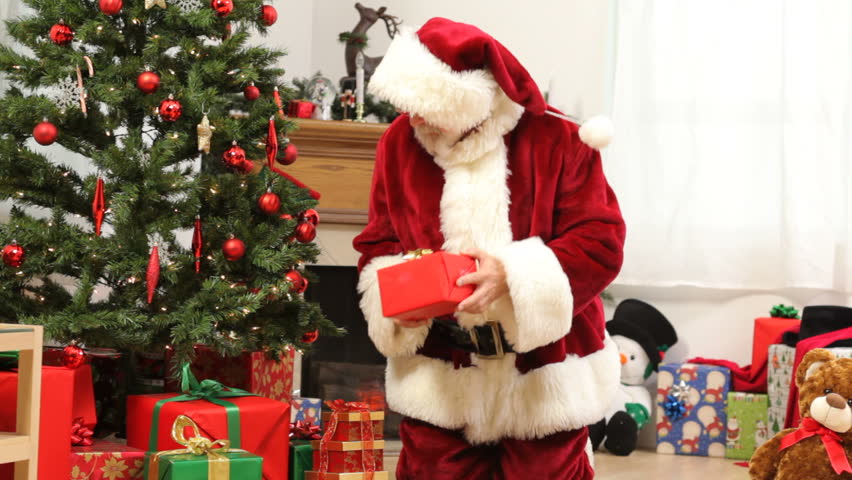 Santa Claus Puts Gifts And Toys Under Christmas Tree Stock Footage ...