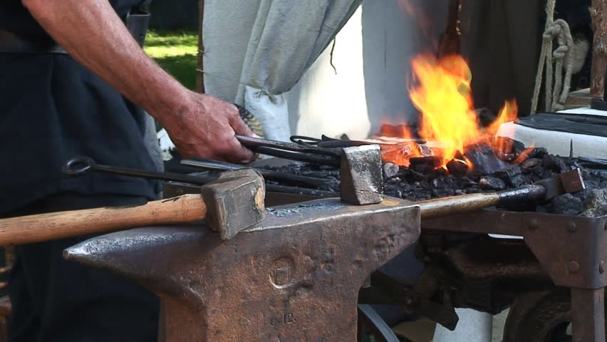 Old Fashioned Blacksmith Forging A Horseshoe On The Anvil. Stock ...