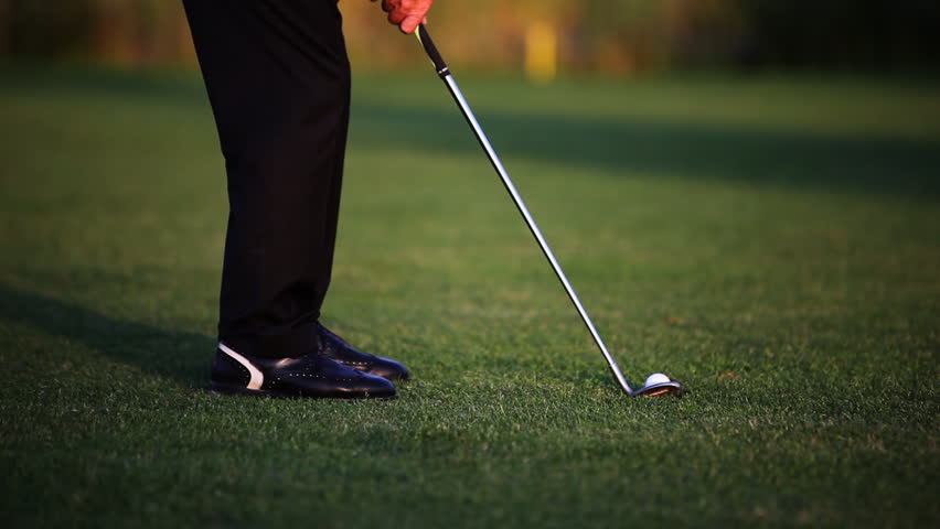 Close Up Of Golf Ball Sitting On Tee With Driver Swings And Hits The ...