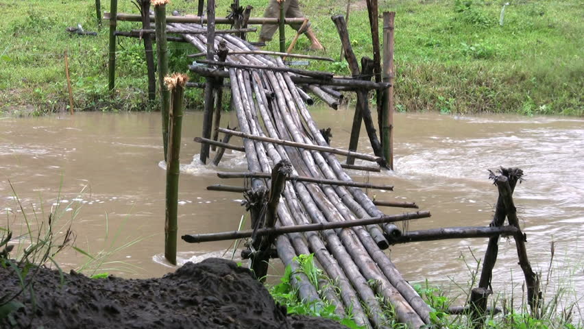 A Man Comes Across A Rickety Old Bamboo Bridge In Kanchanaburi ...