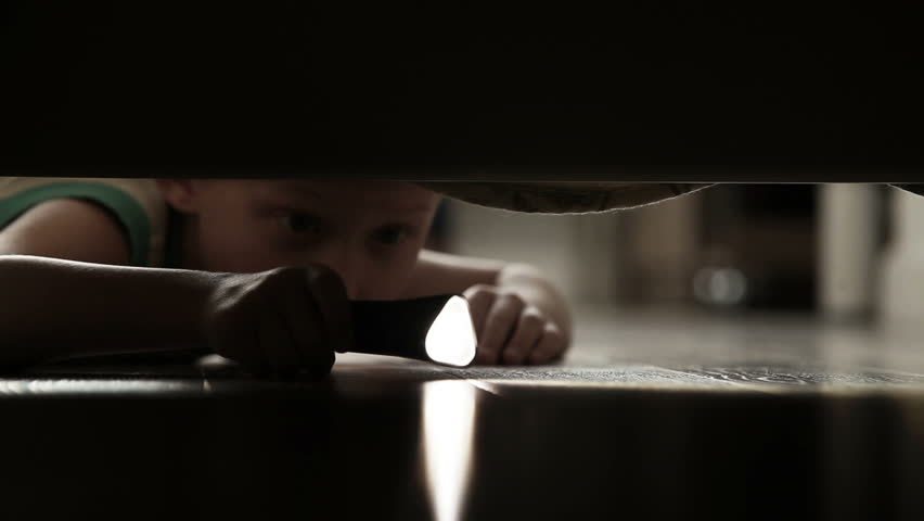 A Little Boy With Torch Groping Around Under The Bed Stock Footage ...