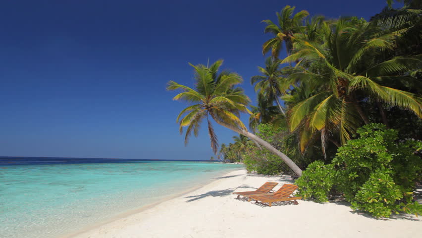 Beach On The Maldives With Sun Bed. Slight Wave Movement And Blue Sky ...