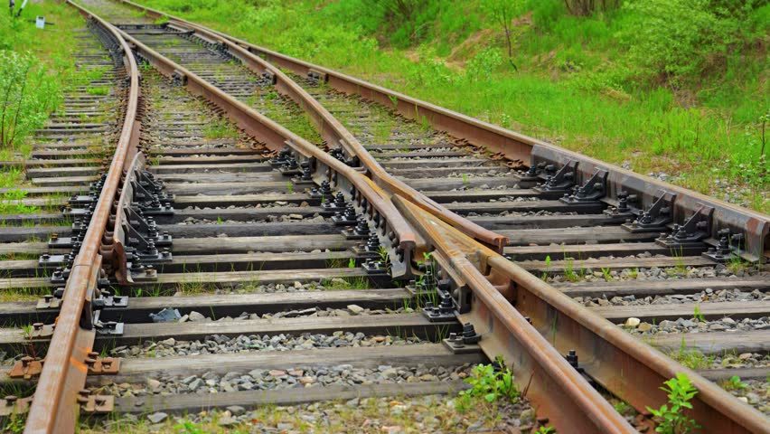 Close Up View Along Wooden Support Beams Of Rusted Railroad Tracks ...