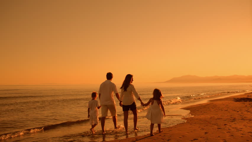 Family Walking Away From Camera On Beach In Sunset Stock Footage Video ...