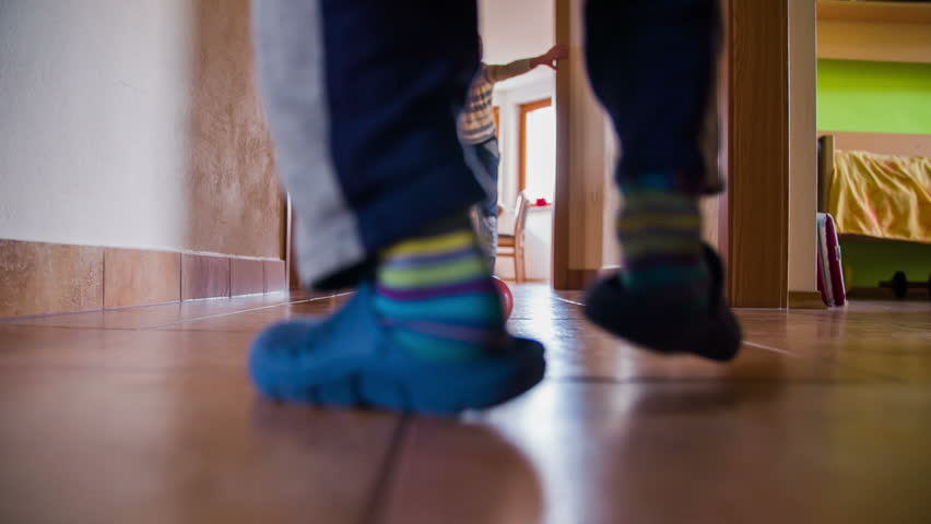 Boy Walking Down The Hall In House Low Angle. Two Boys Playing Soccer ...