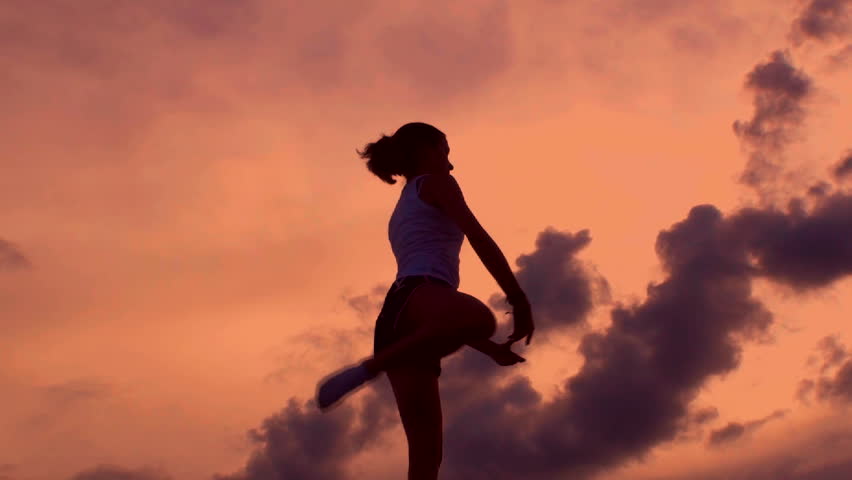 Silhouette Of Teenager Performing Ballet Movements Against Dramatic ...