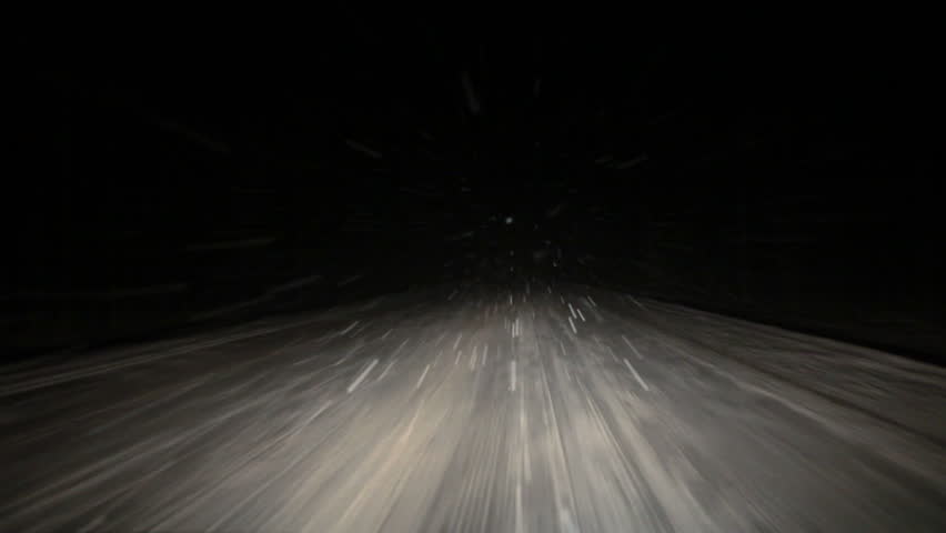 Car Driving On Winter Night Road While Strong Snow Flying Towards In ...