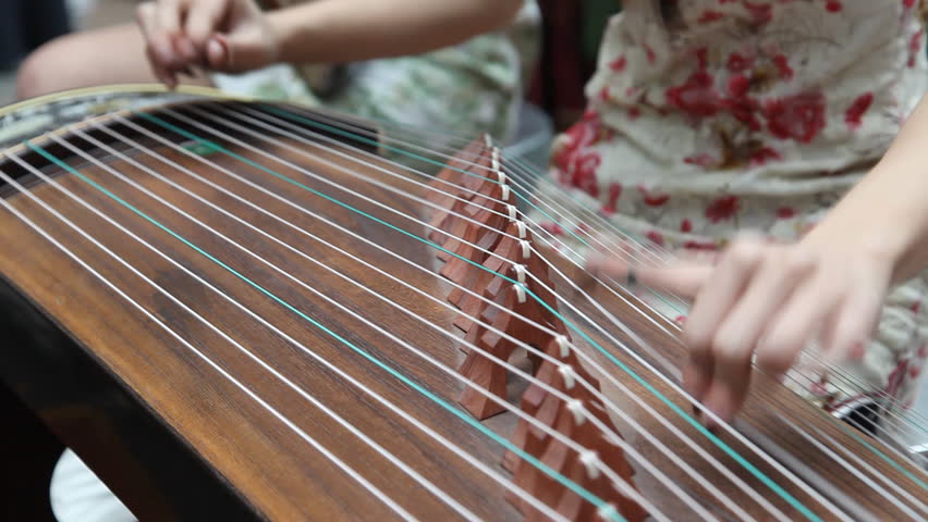 Chinese Traditional Musician Playing Chinese Guzheng.Guzheng, Also ...